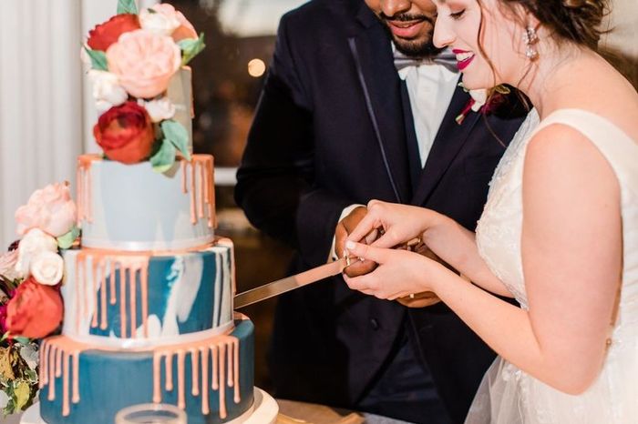 wedding reception cake cutting flower decor bride and groom