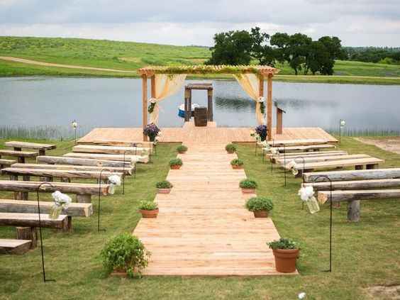 wooden flooring aisle runner outdoor wedding alter lake