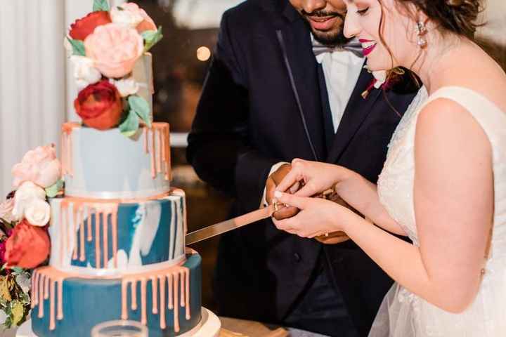 wedding reception cake cutting flower decor bride and groom