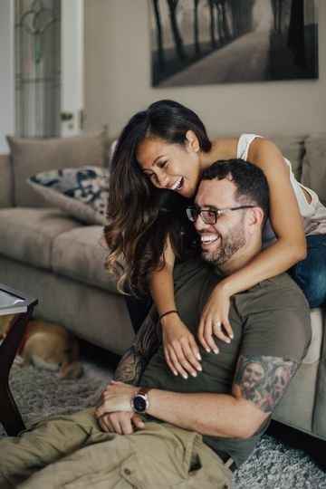 couple laughing sitting on couch