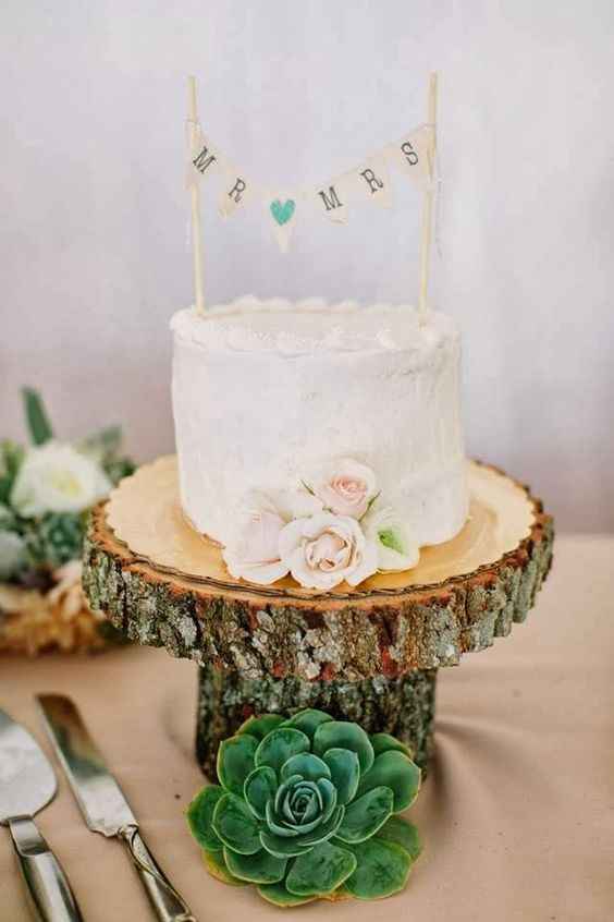 small wedding cake on stand with bunting 