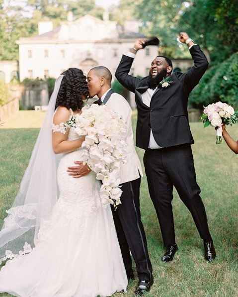 best man jumping for joy at wedding with couples first kiss