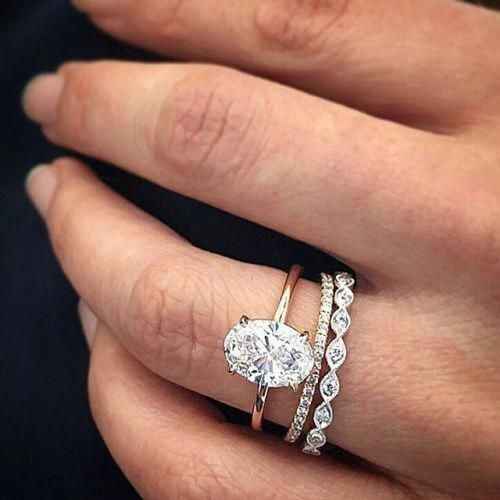 oval ring with stacked rings, twist wedding badn and paved wedding band