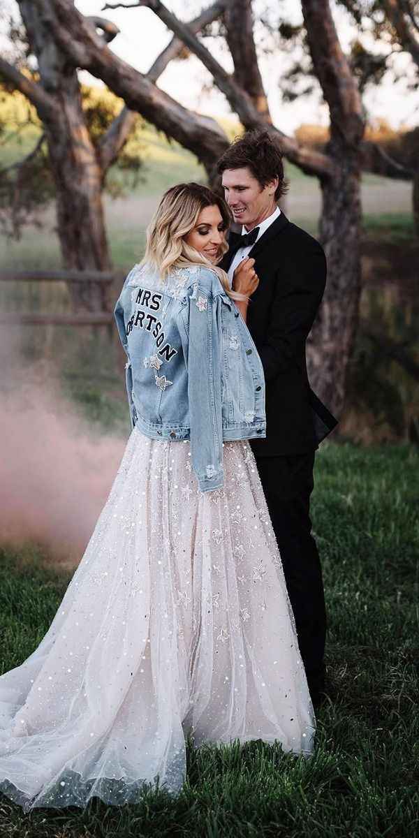 blush wedding dress with a personalized denim jacket 