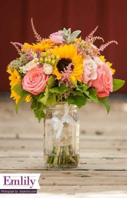 roses and sunflowers in a mason jar