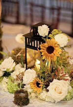 sunflower and white roses in a centerpiece with lantern