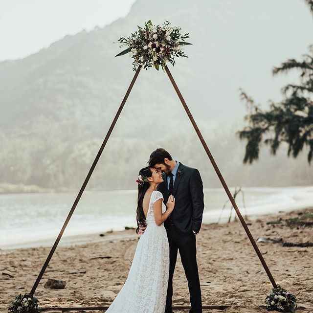 Simple triangle wedding arch with flowers and greenery 