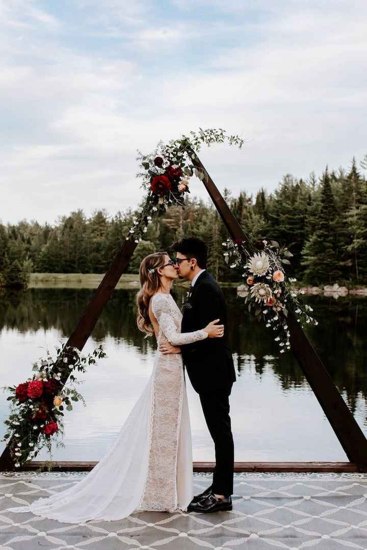 dark wood triangle wedding arch with flowers