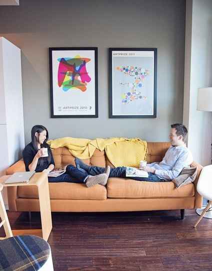 couple relaxing in their apartment on couch 