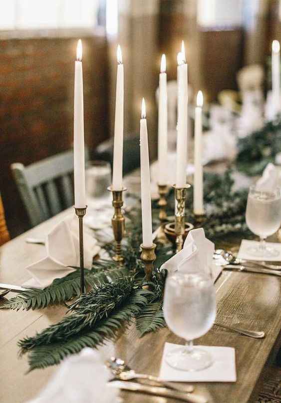 candle stick with greenery wedding centrepiece