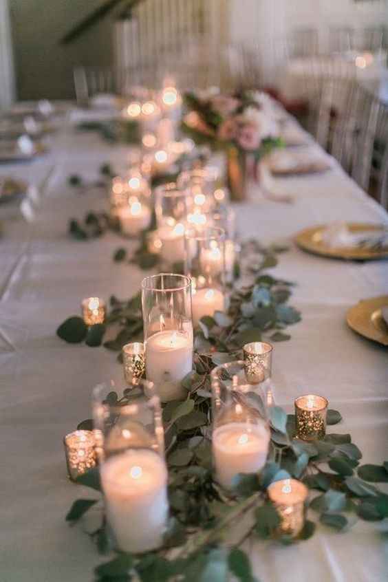 candles in glass with greenery, wedding centrepiece