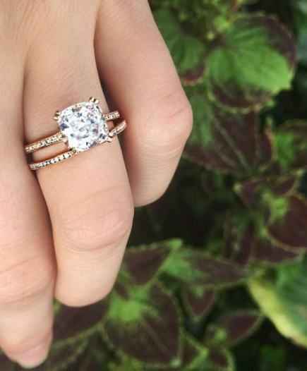 cushion cut engagement ring with paved band and paved wedding band