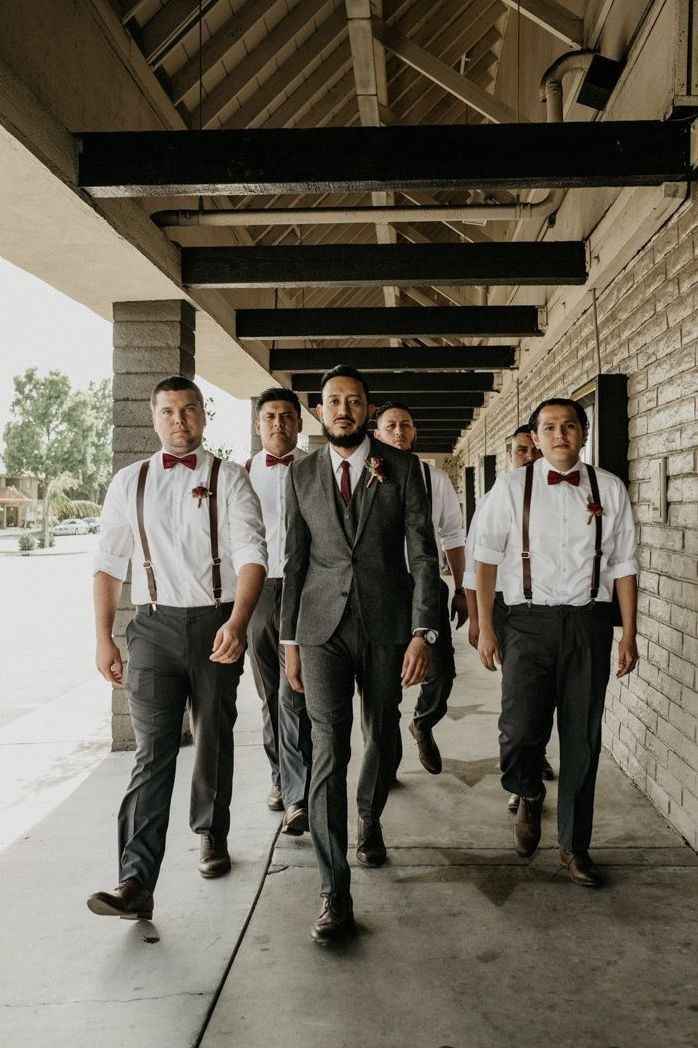 groom in grey tux with burgundy tie, groomsmen in grey pants, white shirt and burgundy suspenders an