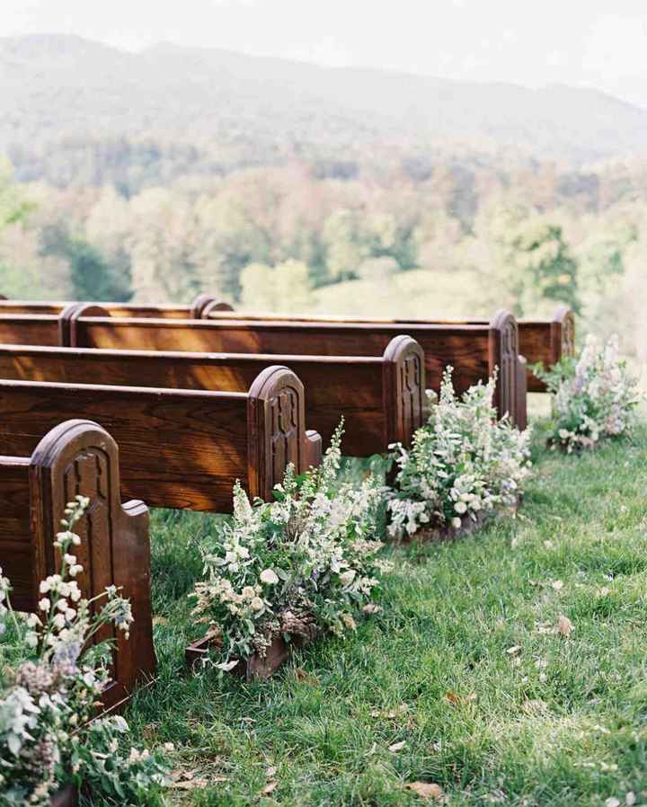 wedding ceremony aisle lined with planters with flowers