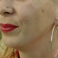 My open pierced nose and ears, and silver earrings in every hole.