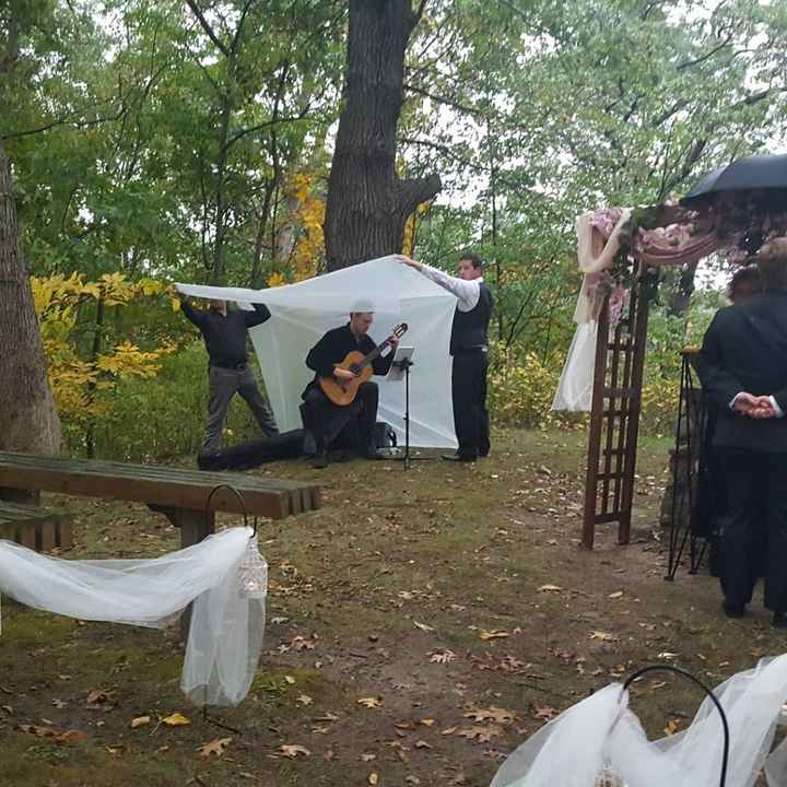 My brother and his friend holding up a tarp for the guitarist.