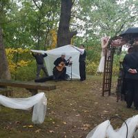 My brother and his friend holding up a tarp for the guitarist.