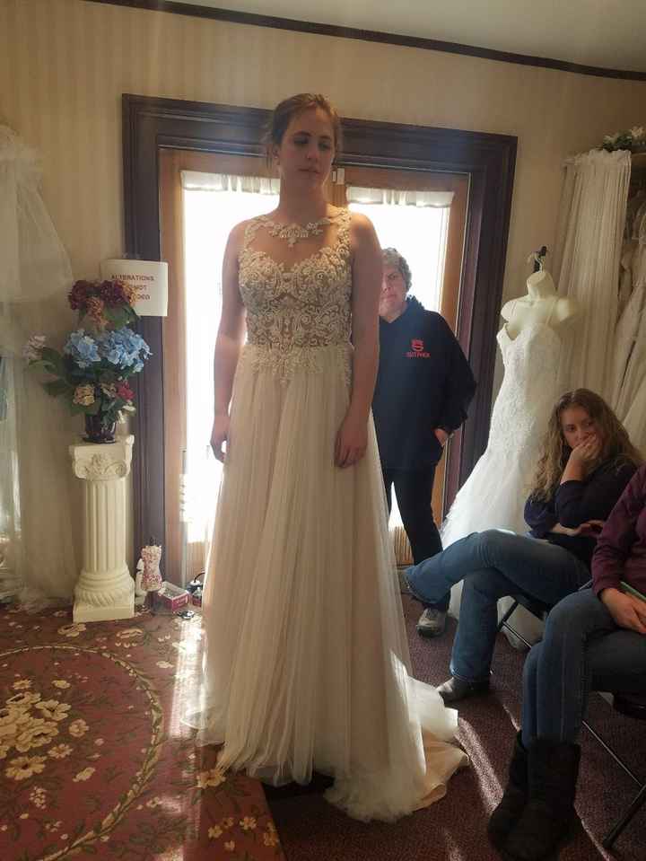 The second one! Love it! Love the illusion neckline. Just not the bling and I want the dress all whi
