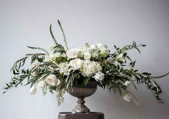 Smitten by these metal vases with overflowing greenery!
