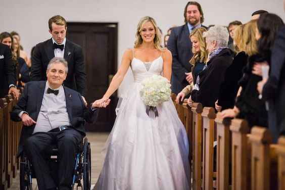 father in wheelchair escorting bride