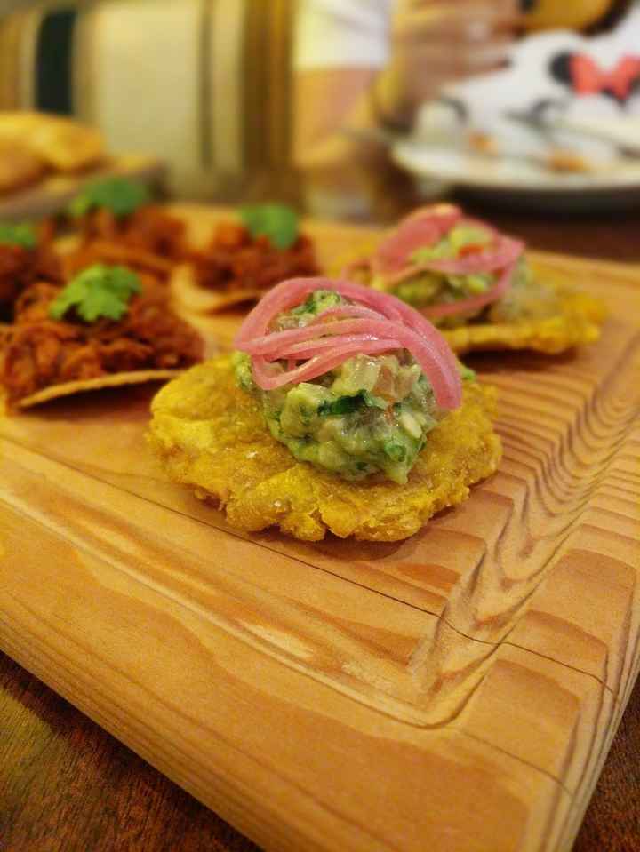 tostones with guacamole and a picked onion