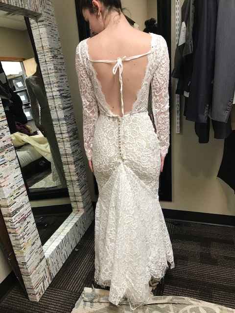 Trying on at the tailor, possibly adding cross ribbon