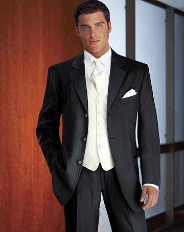 white vest, white tie with a white flower. 