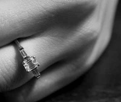 23 small diamonds, and one bigger diamond... I LOVE IT. Lets see some rings my fellow brides.