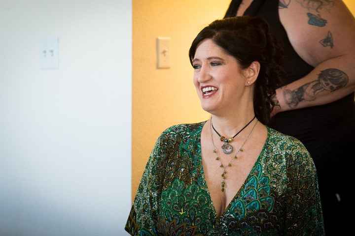 My mom getting her hair done. (she wore a baby picture of me for the wedding)