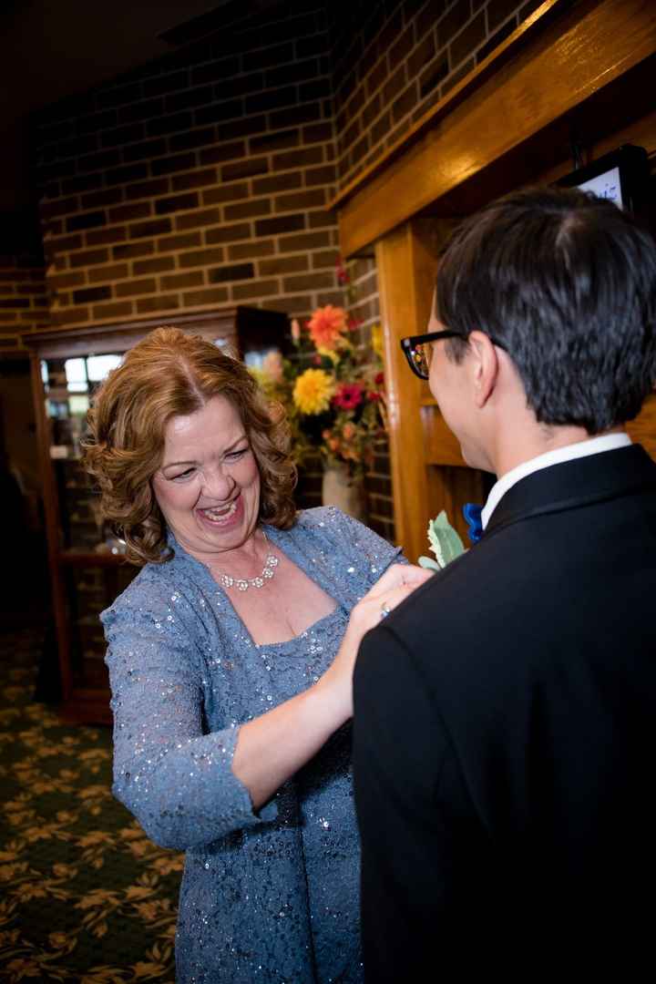Mother of the groom helping with the elusive pins