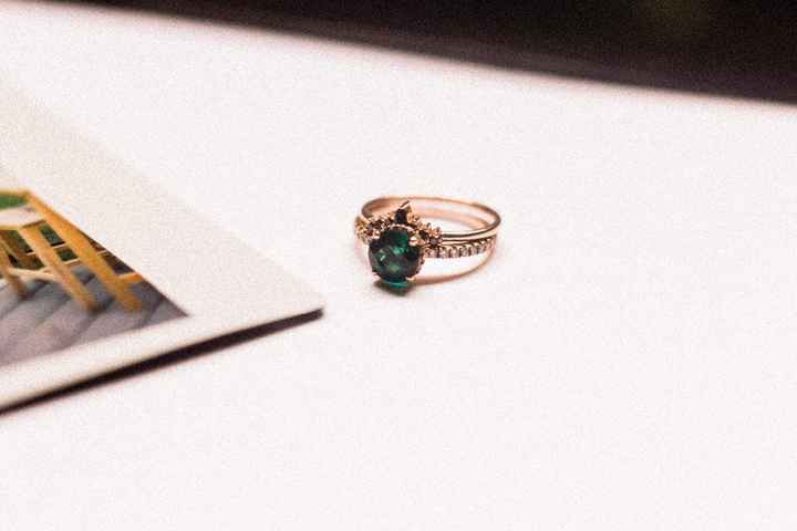 Black diamonds on the band and emerald with white diamonds on the ring