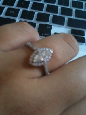 23 small diamonds, and one bigger diamond... I LOVE IT. Lets see some rings my fellow brides.