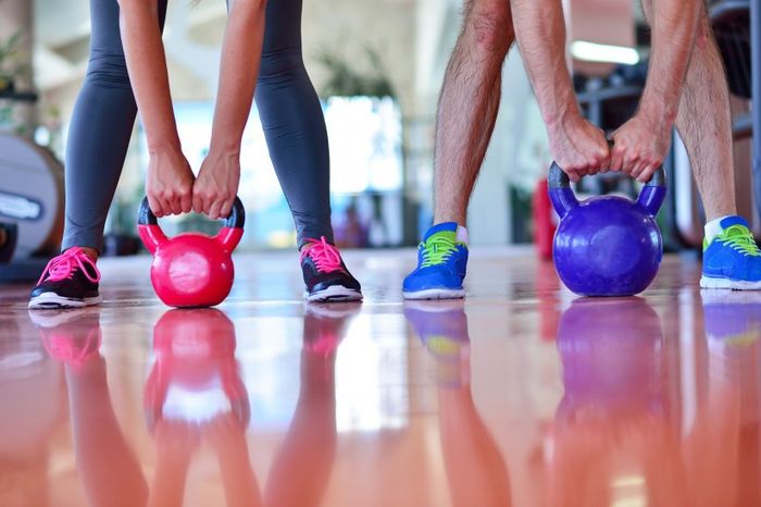 Couple Working Out Together - Gym Kettlebells