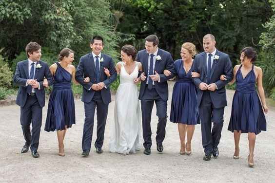 Bridesmaids in navy and groomsman and ...