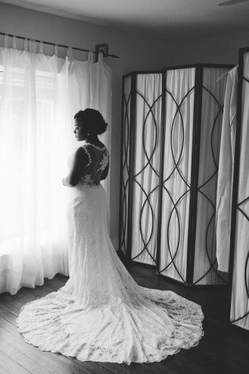 Bride Looking Out the Window in Her Wedding Dress