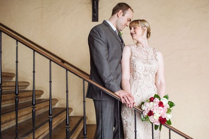 Bride and groom standing on staircase on Valentine's Day wedding