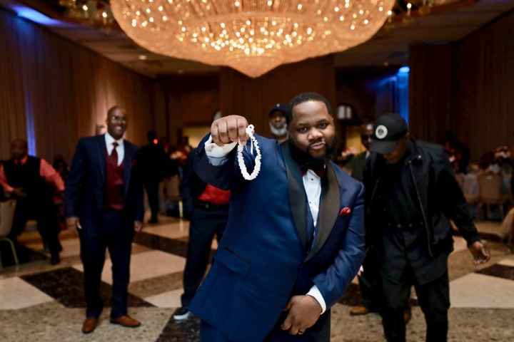 african american groom man garter toss wedding navy suit