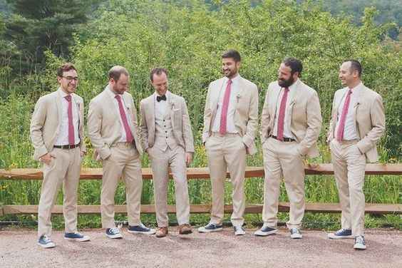Groom and groomsmen in beige/tan suits and long magenta/mauve ties