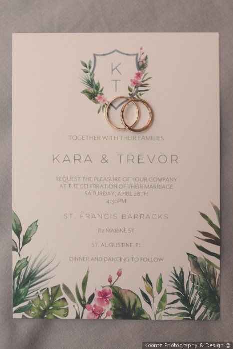Simple invitation for Kara and Trevor with floral design along the bottom