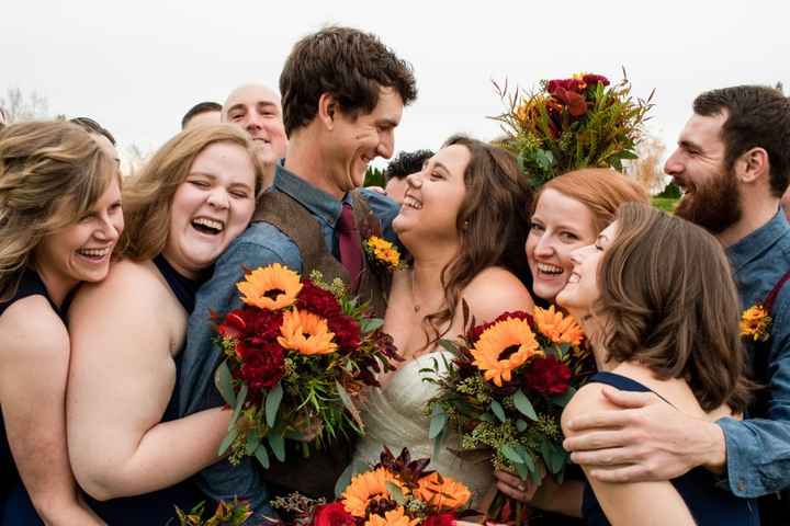 wedding party embracing bride and groom