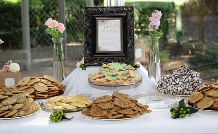 Wedding cookie bar and table decorated with pink flowers