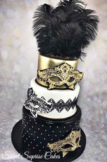 Black and gold wedding cake with masks