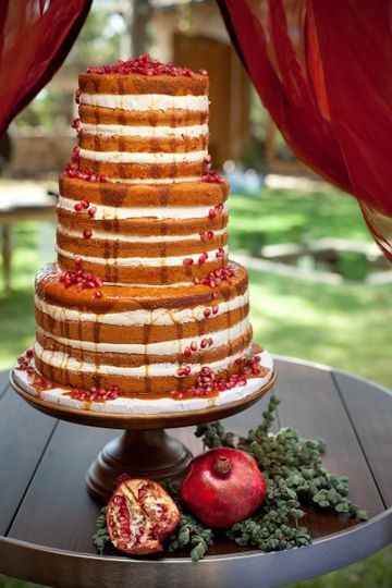 Naked cake decorated with pomegranate seeds and juice