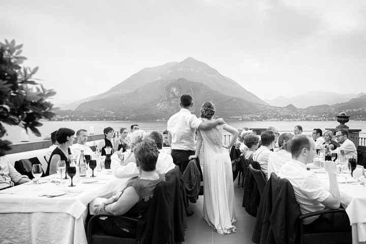Black and white picture of couple and guests looking out toward scenery