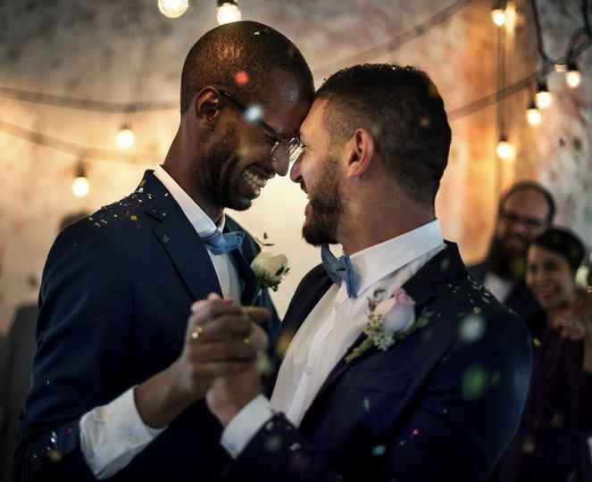 Gay couple dancing amid sparkles