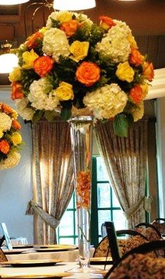 what flowers for black bridesmaids dresses with orange shawls?