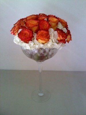 what flowers for black bridesmaids dresses with orange shawls?