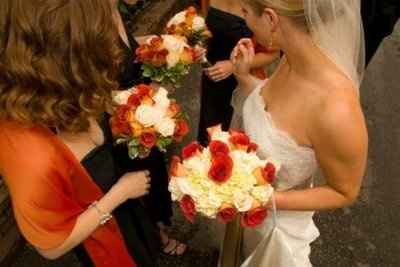 what flowers for black bridesmaids dresses with orange shawls?