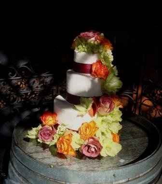 what flowers for black bridesmaids dresses with orange shawls?