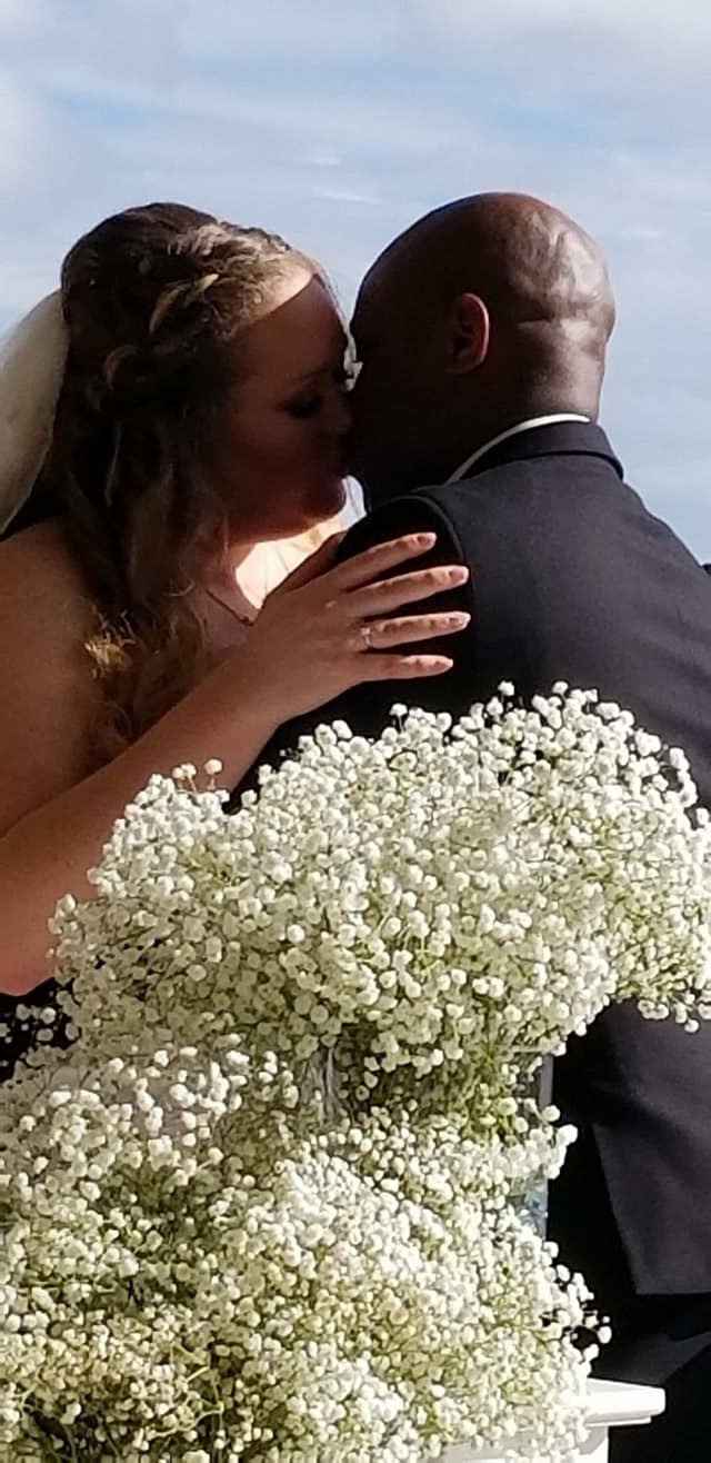First kiss behind alter flowers